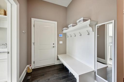 The mudroom has a large walk in closet along with the beadboard bench with coat hooks