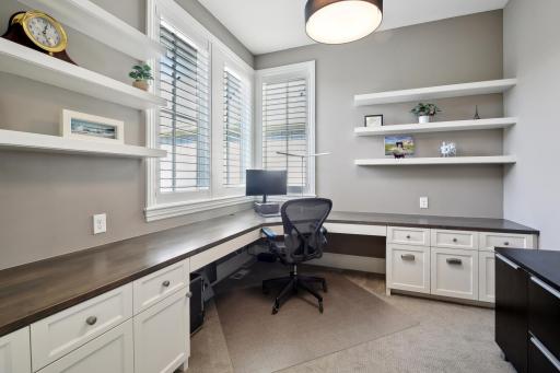Perfect for working from home with an L-shaped desk and plenty of cabinetry
