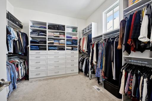 The spacious walk-in closet features 15 drawers for additional storage