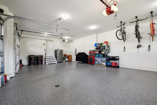 The 3 car garage is heated and decked out with two floor drains, newly epoxied floors and added new springs to the solid wood garage doors