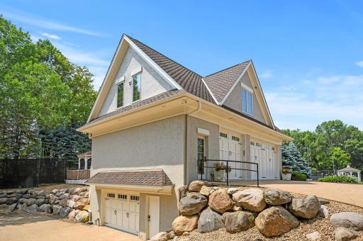 A remarkable 7-car detached garage graces the property, complete with an upper-level loft and a deck.