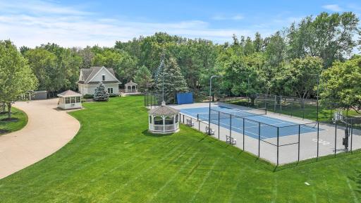 The tennis court, fully fenced for privacy, has been meticulously resurfaced and is equipped with a basketball hoop for recreational fun. Professional-grade Courtsider XL lighting ensures that you can play day or night.