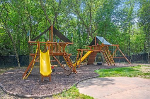 An inviting park area awaits with rubber mulch. Here, you'll find two Rainbow Play Systems.