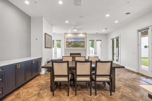 The living room in the guest house is a cozy retreat, featuring a gas-burning fireplace that creates a warm and inviting atmosphere and 10-foot ceilings.