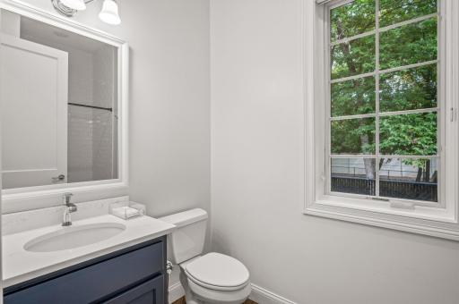 A convenient Â¾ bathroom with tile floors and a quartz countertop is located on the main level of the guest house. Additionally, there is a laundry closet conveniently situated in the hallway.