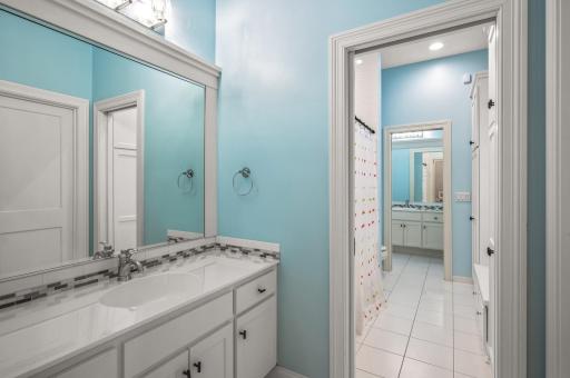 A well-designed jack-and-jill bathroom on the lower level features a tub/shower combo, providing accessibility and convenience for those using the lower bedrooms.