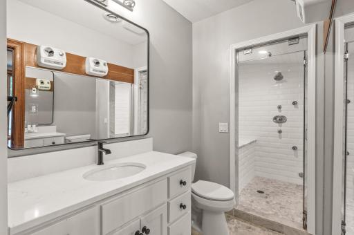 An adjoining three-quarter bathroom features a large walk-in shower for post-workout refreshment.