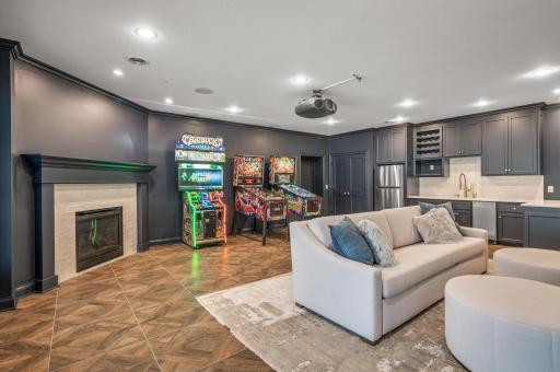 Movie nights reach a new level of enjoyment in the theater room, equipped with a 132-inch screen and a 4K projector.