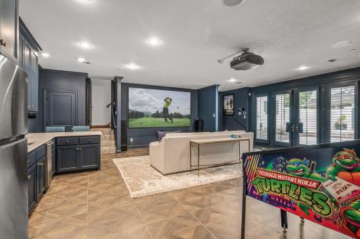 A gas-burning fireplace and an additional wet bar enhance the cinematic experience.