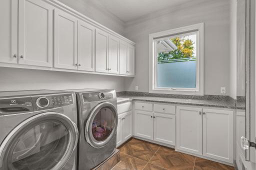 A dedicated laundry room on the main level provides convenience and functionality, simplifying daily chores.