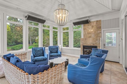 Experience the changing seasons in comfort on the gorgeous four-season porch. It features elegant tile floors, a soaring 13-foot vaulted ceiling, a gas-burning fireplace with marble surround, and seamless access to the backyard.
