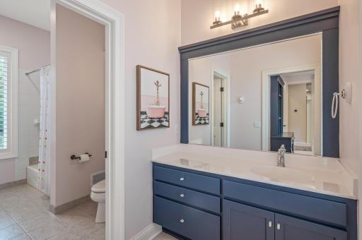 A thoughtfully designed jack-and-jill bathroom connects the bedrooms, offering a tub/shower combo and ensuring convenience and privacy.