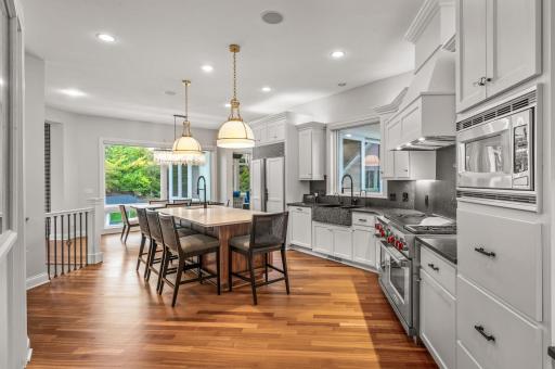 Top-of-the-line stainless steel appliances, including a SUBZERO refrigerator and a 6-burner WOLF gas range.