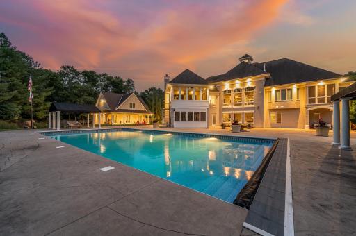 The manicured lawn is complemented by an in-ground sprinkler system, ensuring lush greenery throughout the seasons. A Â¾-mile paved trail lined with towering pine trees bordering the estate making it a delightful space for nature walks.