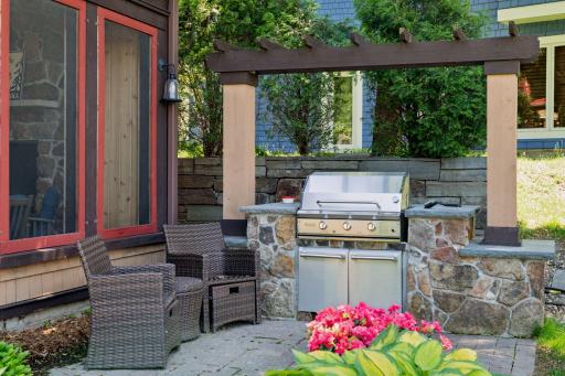 One of the custom paver patios features an outdoor cooking space with a built-in ProFire gas grill offering a dedicated gas line.