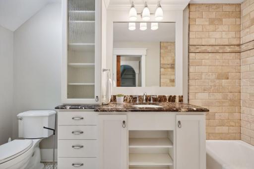 The private full bathroom enjoys heated tile flooring and high-quality finishes.