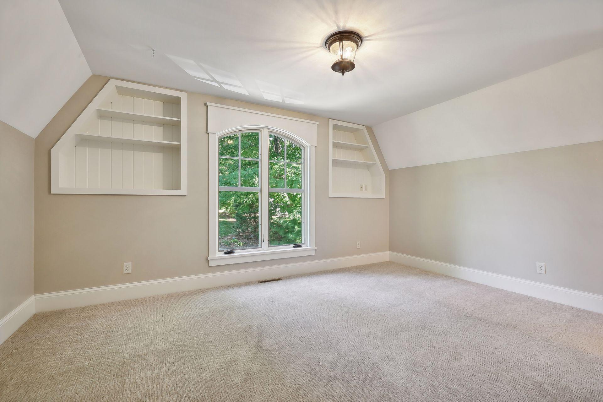 Junior Bedroom #3 is a private suite with built-in bookcases, a built-in homework nook and full bathroom.