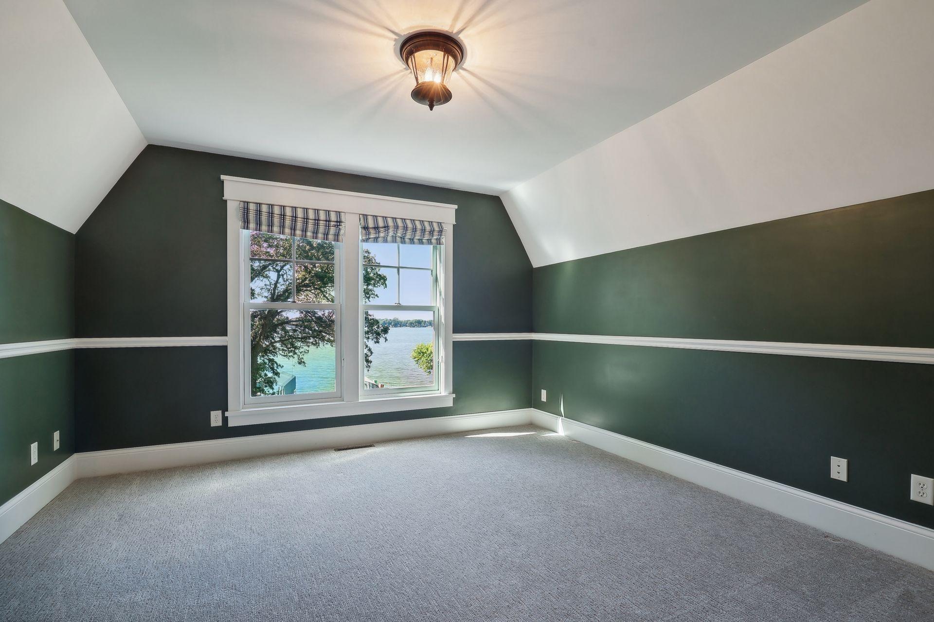 The first junior bedroom over looks the backyard and lake and features a walk-in closet.