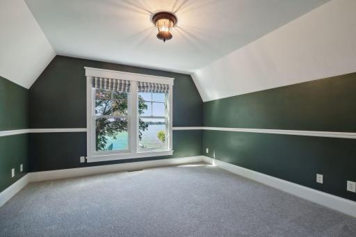 The first junior bedroom over looks the backyard and lake and features a walk-in closet.