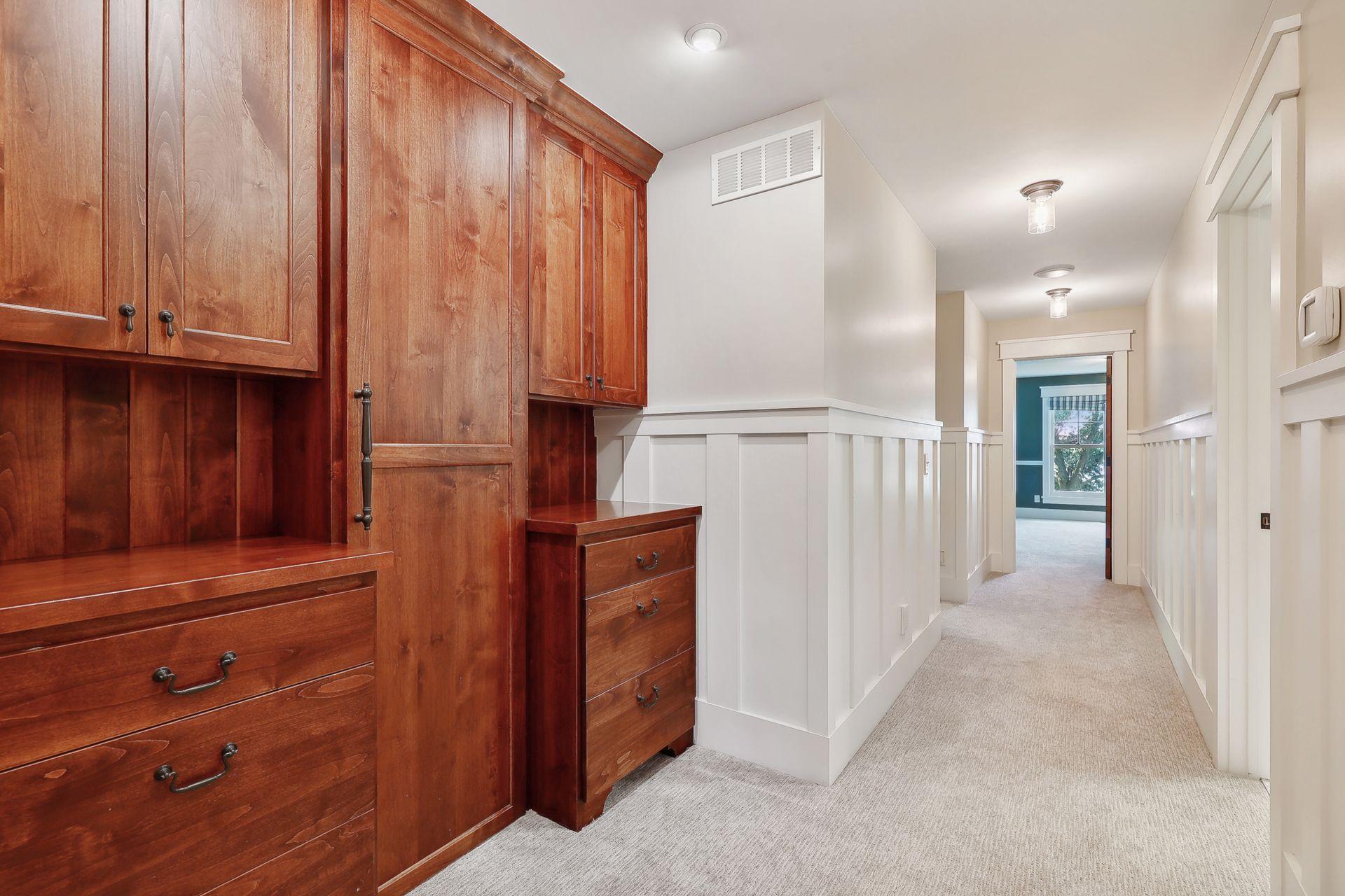 Throughout the upper level you will find built-in cabinetry, this door hides the upper level laundry.