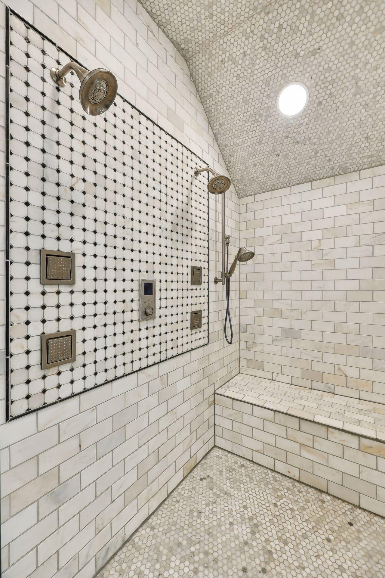A luxurious addition - a private shower with gorgeous marble tiling.
