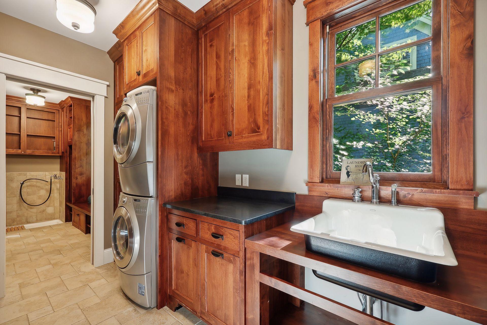 Thoughtfully designed, the main level Laundry Room and Mud Room will help keep you organized with extensive cabinetry, a folding counter, built-in lockers and handy dog washing station!