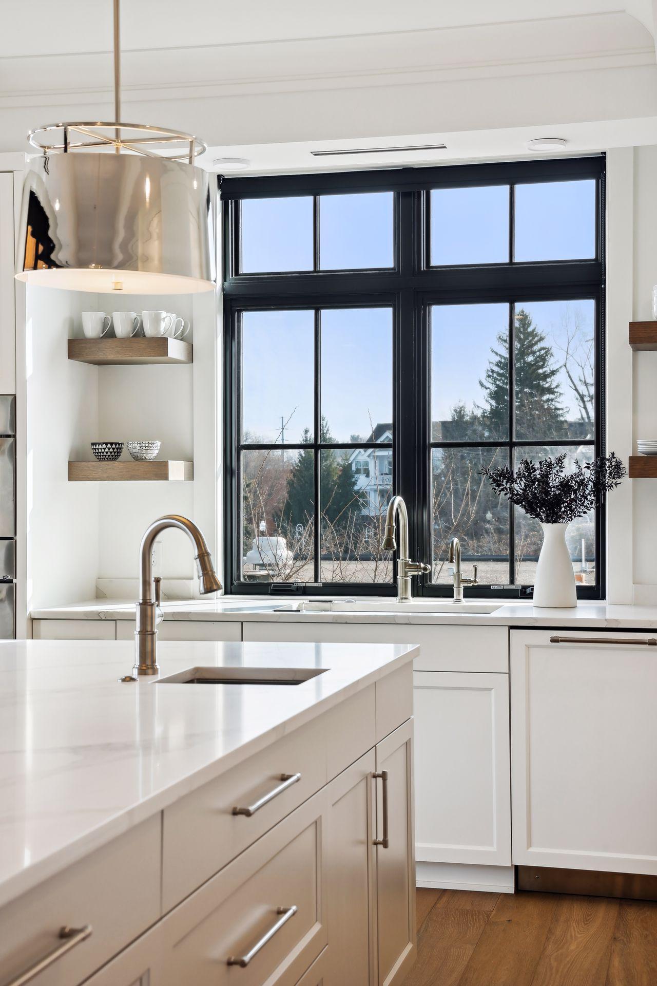 Main sink with window view plus a smaller prep sink in the center island