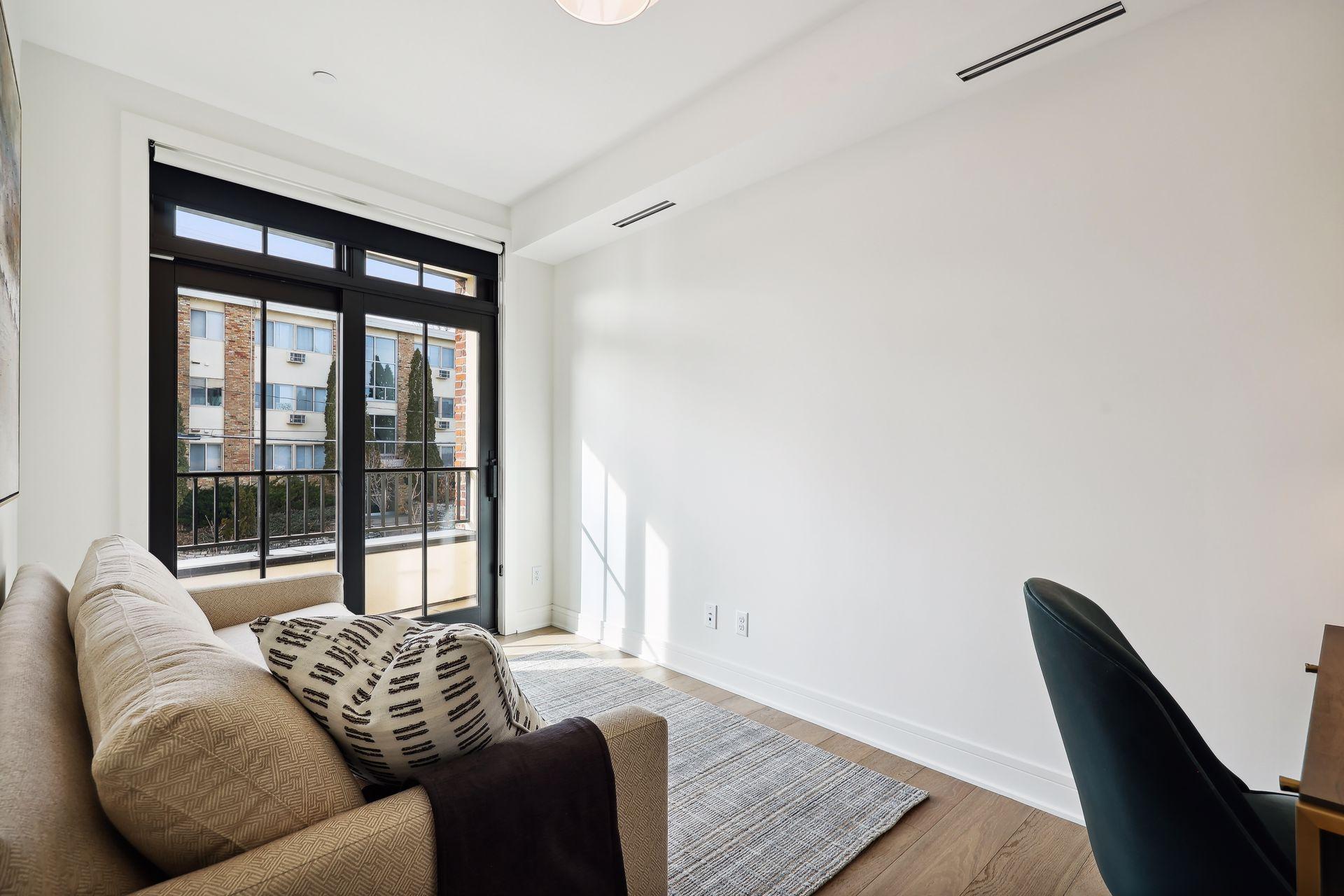 Small sitting room within the primary suite serves as a reading nook, home office space, exercise area, etc.