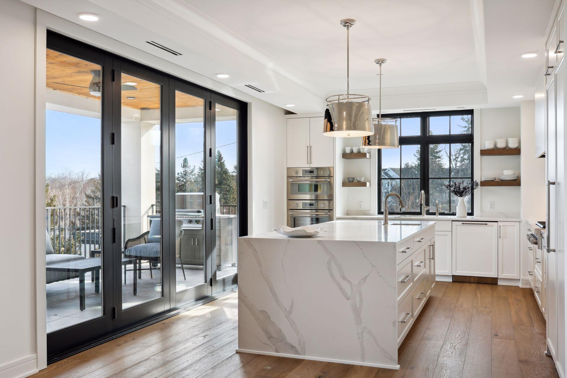 Kitchen highlights include top of the line appliances, large center island, and access to the covered porch