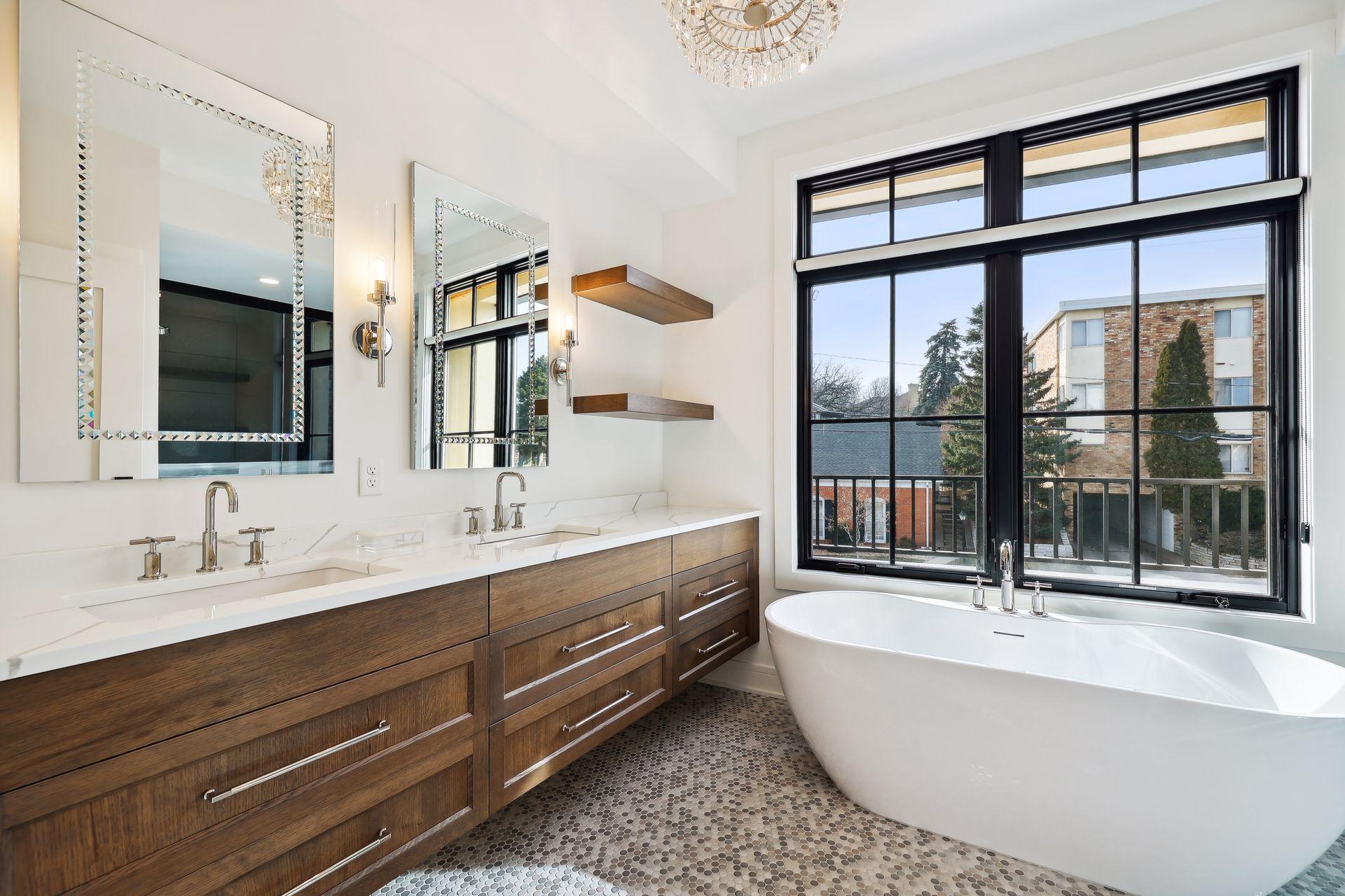 Spa-like primary bath with dual sinks, soaker tub, walk-in shower, and heated floors