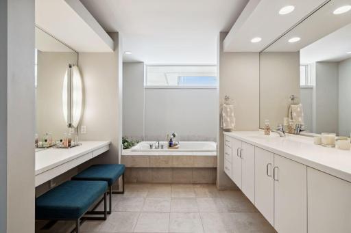 Primary Bathroom with deep soaking tub, shower and vanity area