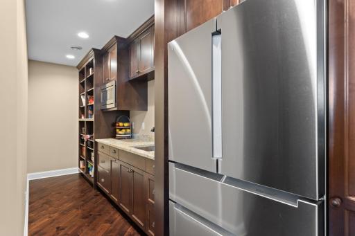 The butler's pantry offers additional refrigerator space, sink, plenty of prep space & cabinet storage