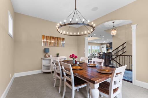 The formal dining room features a statement chandelier