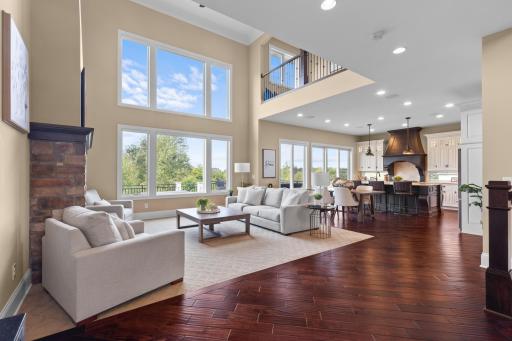 Step into the vaulted living room with soaring windows that highlight the views