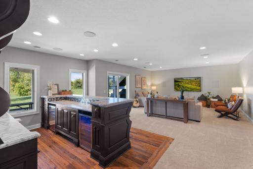 The walkout lower level offers a fantastic space to entertain including a wet bar & cozy family room