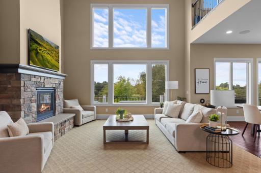 The living room offers a cozy space to unwind by the stone fireplace