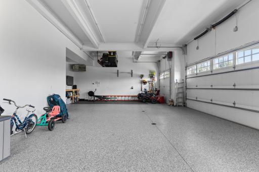 Walk out to the heated 4-car garage that offers plenty of space for your vehicles & more