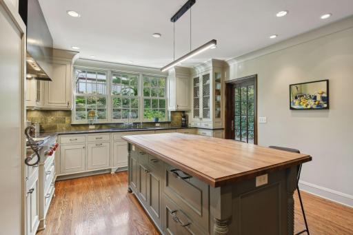 Custom cabinets, large center island, great natural light, access to covered patio area.