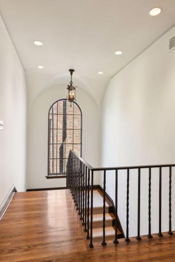 Wrought iron railing, arched window, unique ceiling. One of a kind home.