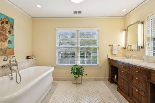 High end owner suite bathroom with large soaking tub .