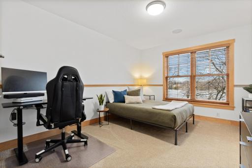 Bedroom 4 of 4 is on the SW corner of the upper level and has full lake views and a large walk-in closet.