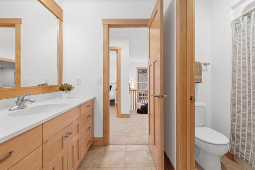 The walk through bathroom can be accessed from both the upper level hallway and the bedroom. It also features a pocket door between the vanity and tub/shower area that allows for this space to be used by multiple people at once.