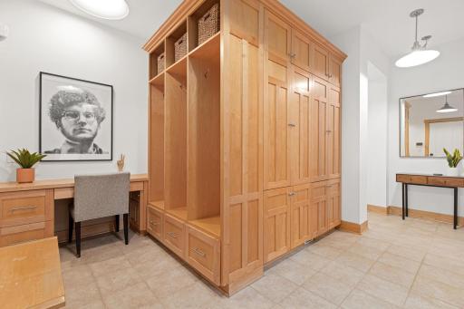Keep everyone organized with this fabulous mudroom area! The built-in's feature 3 open locker stalls with boot drawers and shelving as well as additional closed hanging storage. A built in bench opens for more storage.