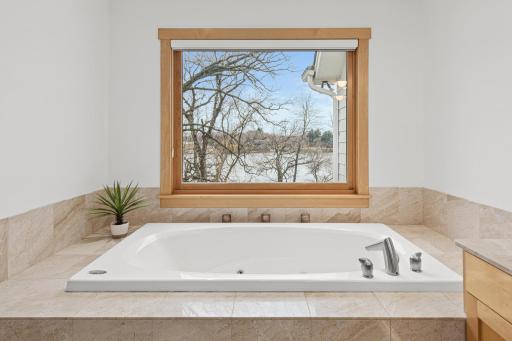 The marble tile deck around the tub allows you to keep all of your pampering products close at hand.