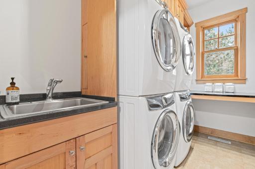 The main floor laundry room has fantastic storage, a double pair of Electrolux front loading washers and dryers to keep the wash moving, a large folding counter and a sizable closet.