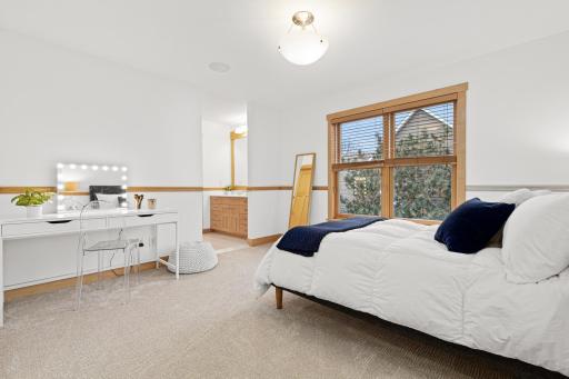 This bedroom has a substantial walk in closet, peak-a-boo lake views, and a connecting Jack and Jill bathroom with a private bathroom vanity.