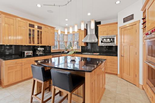 A corner pantry provides terrific storage space for all of your kitchen staples. The rollouts in the cabinets, paired with deep drawers, creates the ability to effortlessly store and organize an expansive collection of dishes, pans, and gadgets.