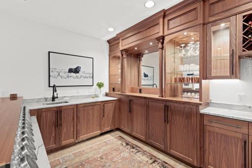 This striking area is nearly a full second kitchen! To the right of the sink is the paneled dishwasher and ice maker. Just add a range and you have a full second kitchen. This lower level would make a great option for intergenerational living.