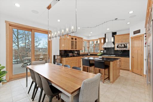 The chef's inspired kitchen has a large island perfect for prep space, a walk-in pantry, excellent storage in upper and lower cabinets, and a patio door that walks out to the 432 sq foot maintenance free deck overlooking the lake.