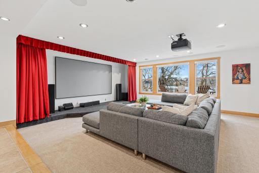 Enjoy movie nights in your very own theatre room! The current owners turned this ordinary family room into an extraordinary at home movie experience with a 4k projector, 11 ft diagonal screen, automatic theatre curtains and blackout window coverings